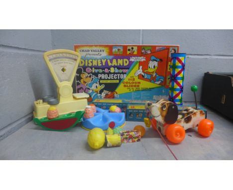 A collection of vintage toys, Disneyland Give-A-Show projector, sweet shop stalls and pretend sweets packets, kaleidoscope, e