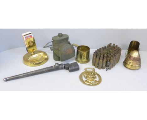 Military related items including a brass matchbox holder/ash tray with insignia, spike bayonet, ammunition shells, a bike lam