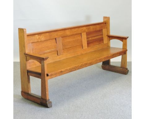 An early 20th century light oak pew, with a panelled back, 178cm