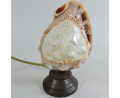 A carved cameo shell, converted to a table lamp, 20cm tall, together with an oriental teacup