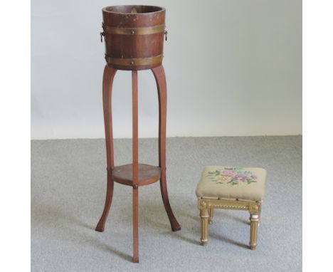 An oak and brass bound coopered jardiniere on stand, bearing a label for R. A. Lister & Co., 101cm tall overall, together wit