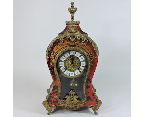 A boulle style brass and faux tortoiseshell mantle clock, with an enamel dial, 44cm tall