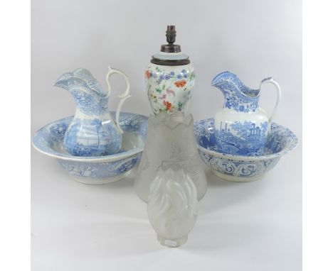 A blue and white jug and bowl, together with another, a pottery table lamp and two glass shades 