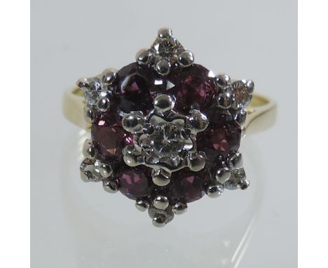 An 18 carat gold ruby and diamond cluster ring