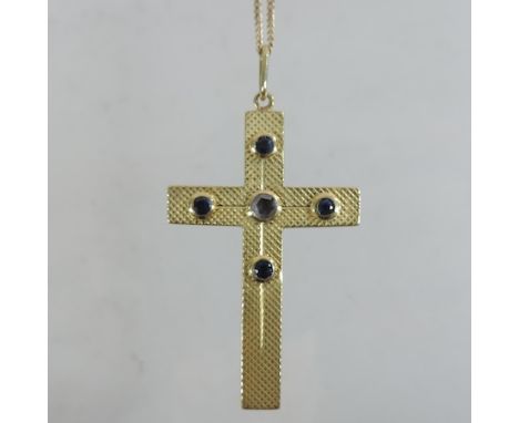 An unmarked gem set cross pendant, with engine turned decoration, on a fine 9 carat gold chain