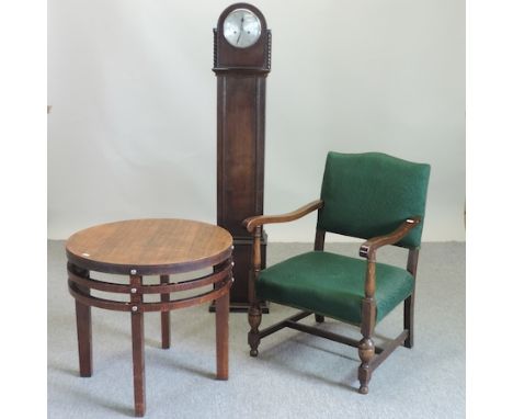 An early 20th century oak cased granddaughter clock, 138cm tall, together with a green upholstered open armchair, and a circu