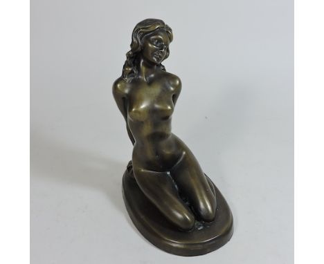 A bronze figure of a kneeling nude lady 