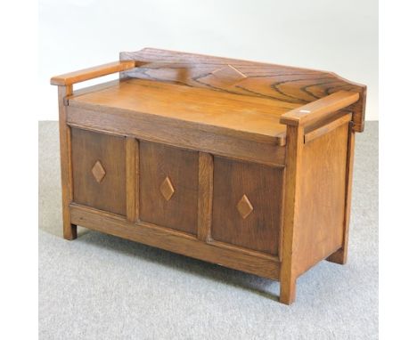 A 1920's light oak box settle, with a rising seat, 78cm