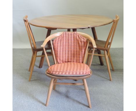 An Ercol light elm drop leaf dining table, 110x120cm, together with a pair of spindle back dining chairs and an armchair