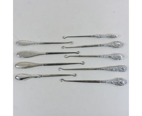 A collection of silver handled button hooks 