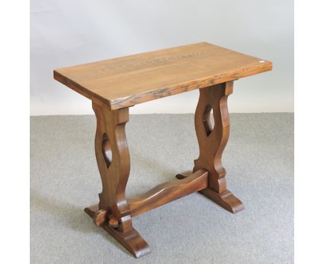 An early 20th century light oak side table, on a trestle base, 82cm