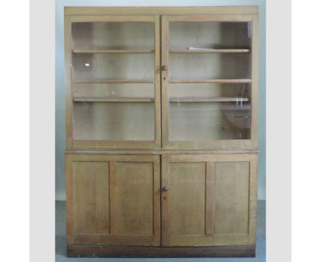 An early 20th century light oak and pine glazed cabinet, with panelled doors below, 152cm