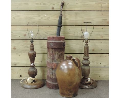 A red leather umbrella stand, painted with an armorial crest, together with a carved wooden table lamp, another and a stonewa