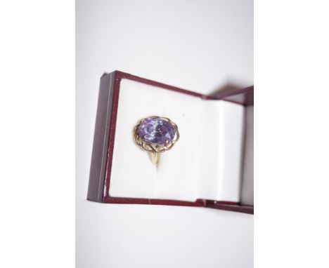 9 carat gold dress ring with large purple stone 