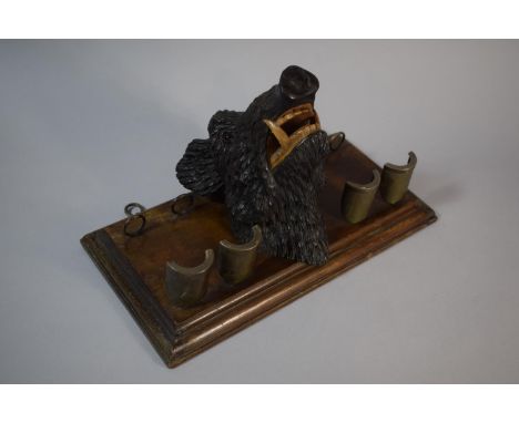 An Interesting Black Forest Carved Boar's Head Wall Hanging Pipe Rack with Four Holders. Glass Eyes Plinth 31.5x16cms 