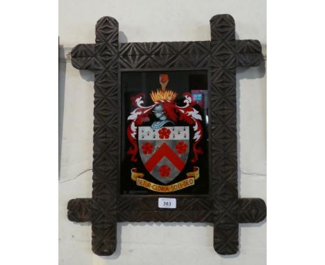 A Reverse Painted Armorial Glass Panel in a Chip Carved Frame. 53x43cms 