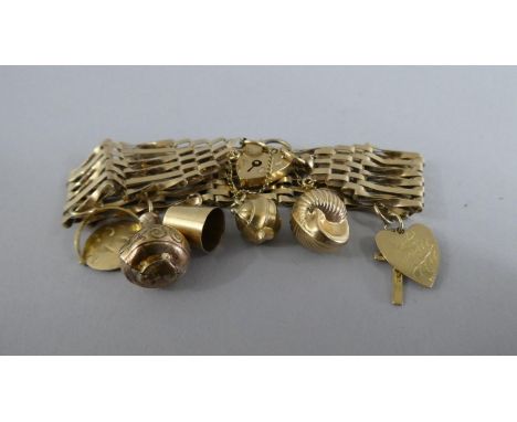 A 9ct Gold Gate Bracelet with Padlock Clasp and Six Charms. 19.7gms 