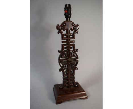 A 20th Century Carved and Pierced Chinese Hardwood Table Lamp. 43cms High 