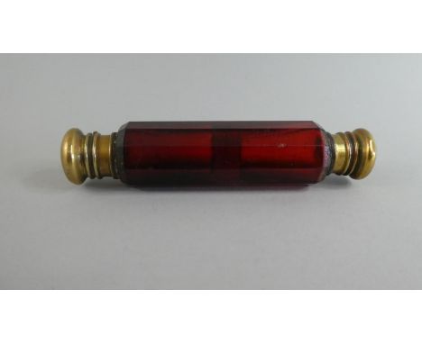 A Late 19th Century Double Ended Ruby Glass Scent Bottle with Gilt Snap Shut Stoppers. 12cms Long 