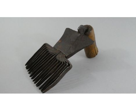 An Early Iron Wooden Handled Wool Comb with Etched Decoration. 18cms High 