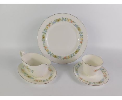 A Royal Doulton porcelain part dinner and tea service decorated in the Pastorale pattern, comprising gravy boat on stand, pai