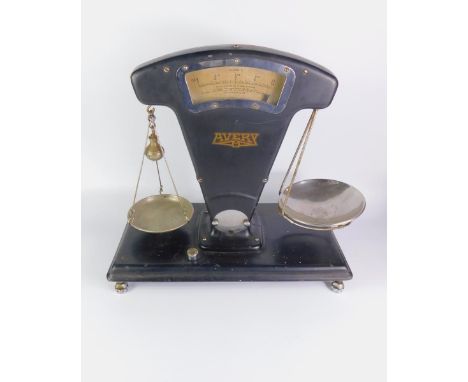 A set of Avery black enamelled kitchen scales, Class C, to weigh 2lb, on a rectangular base and adjustable feet, 48cm, x 26cm