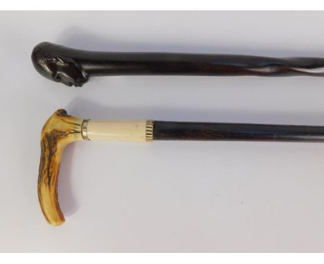 A bone and hardwood walking stick with a horn handle, 87.5cm long, together with an African figure carved ebony walking stick