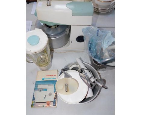 A Kenwood Chef, model A701A, with bowls, beaters, whisks, cutters, blender, instructions and recipe book.