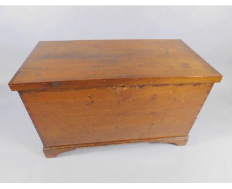 A Victorian pine trunk, raised on bracket feet, 103.5cm x 52cm x 52cm.