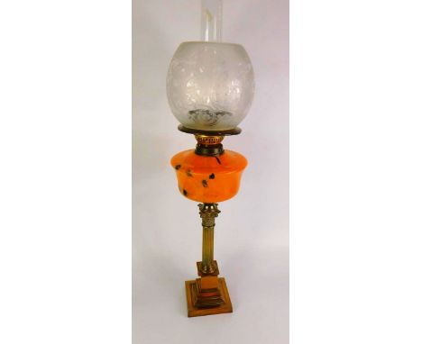 A Dimplex brass Corinthian column oil lamp, with a mottle orange glass reservoir, and a frosted glass shade etched with lions