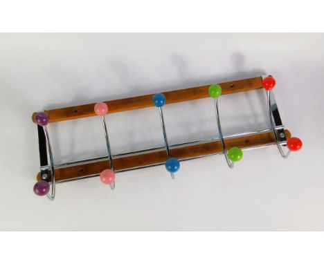 A Vintage atomic wall mounted coat rack, chrome and coloured balls, oak mounted, 50.5cm long.