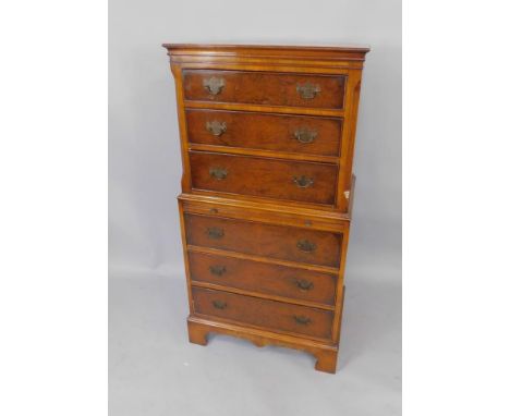 A burr walnut and mahogany chest on chest, with three drawers over a brushing slide and three further drawers, raised on brac