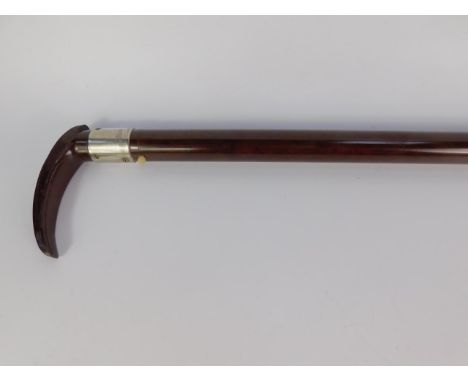 An early 20thC Bakelite walking stick, with torch attachment, 79.5cm long.