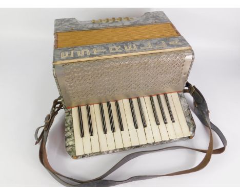 An Estrella accordian, twelve button, cased.
