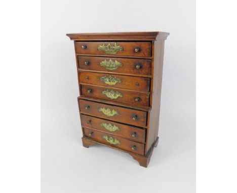 A George III mahogany apprentice chest on chest, of seven drawers, raised on bracket feet, 21.5cm x 9.5cm x 31cm.