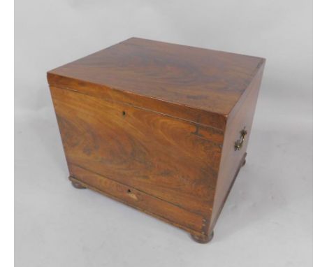 A George III mahogany commode with brass carrying handles, and frieze drawer, raised on bun feet, 53.5cm x 45cm x 45cm.