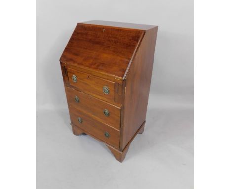An Edwardian mahogany and satinwood cross banded bureau, the fall flap with shell paterae inlay opening to reveal drawers and