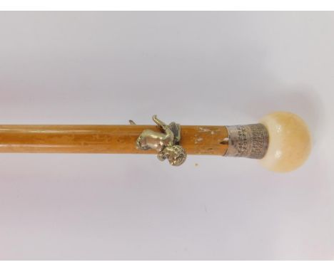 A Victorian malacca walking stick with an ivory ball knop, wire metal two part cherub grip and silver ferule, 92cm long.