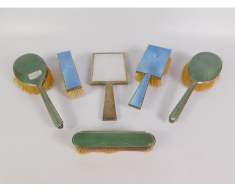 An Edward VIII silver and turquoise guilloche enamel three piece dressing table set, comprising hand mirror, hair and clothes