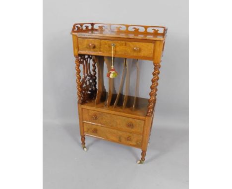 A Victorian walnut Canterbury whatnot, with a fretwork gallery above a single frieze drawer, above six recesses over two furt