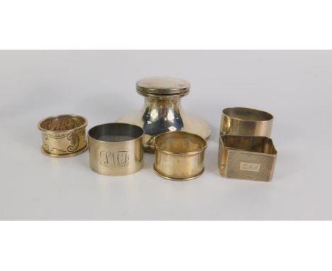 A George V loaded silver capstan inkwell, Birmingham 1910, and five silver napkin rings, 9.06g all in.