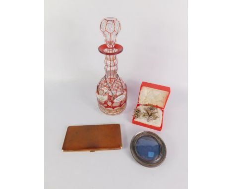 A Bohemian faceted ruby overlaid cut glass decanter and stopper, enamel whisky and port labels, Victorian silver strut photog