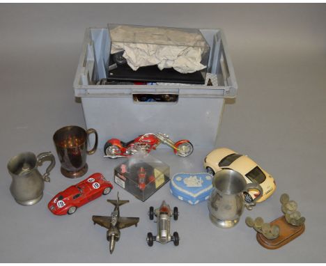 Mixed lot of collectables including a Beniton steering wheel, racing helmet, penguin table lighter in the form of a jet plane