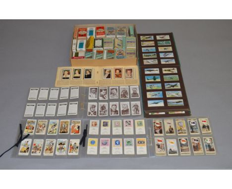 A collection of cigarette cards together with vintage cigarette boxes