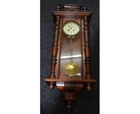 A Vienna wall clock with pendulum and key. Approx 1m long.