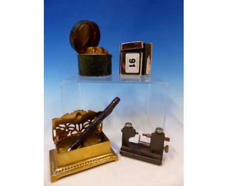 A GREEN LEATHER MOUNTED BRASS INKWELL, A CHROME INKWELL, A PROPELLING PENCIL, A BRASS POSTAGE STAMP CASE AND A WATCH MAKERS P
