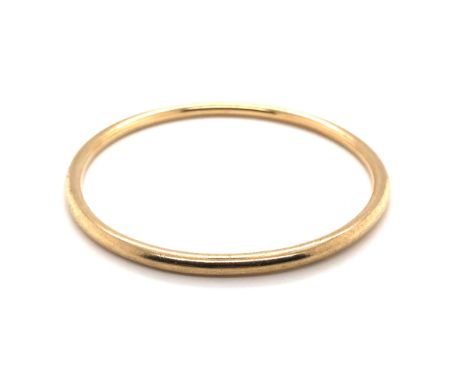 A 9ct GOLD BANGLE, DATED BIRMINGHAM 1977, 24.8grms. DIAMETER 7cms. 