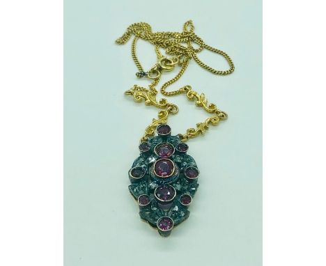 A Ruby and Diamond necklace set on an 18ct yellow gold chain.