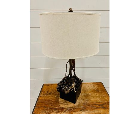 A Bronze Grape and vine themed lamp on a slate base with a white shade.