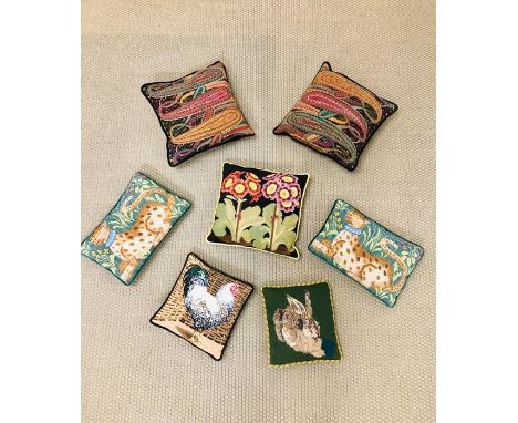 A selection of seven cushions, all velvet backed in a tapestry needle point style 